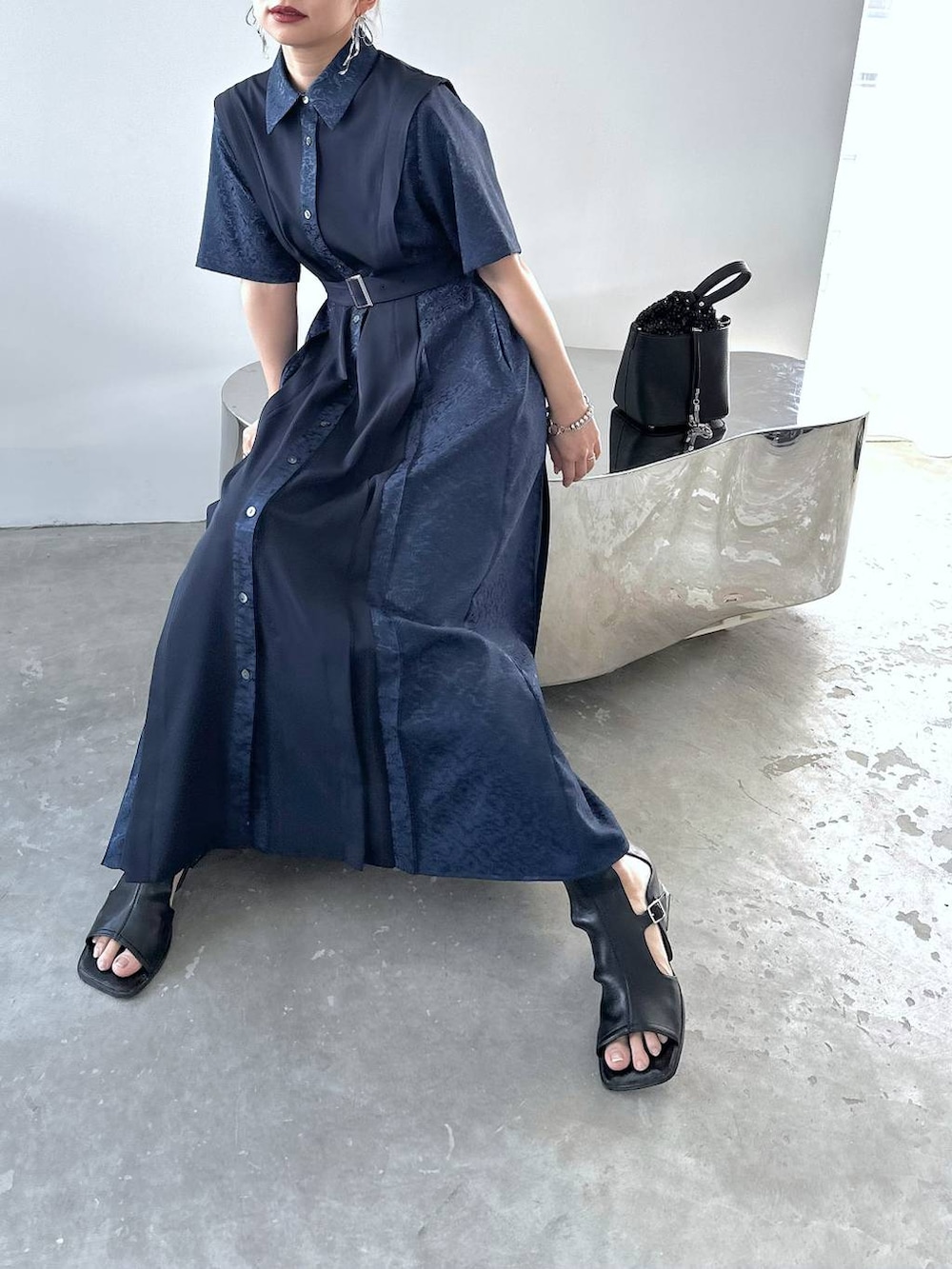 ブルー系のワンピース、ブラック系のショルダーバッグ、ブラック系のサンダルを着用したレディースの春コーディネートの3枚目の写真