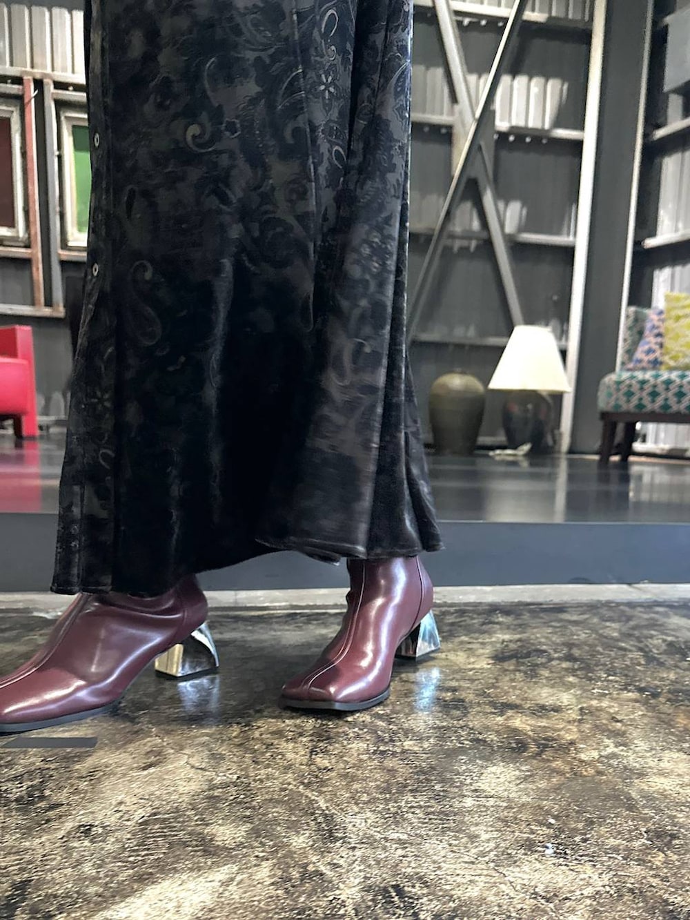 ブラック系のワンピース、レッド系のブーツ、ブラック系のショルダーバッグを着用したレディースの秋コーディネートの9枚目の写真