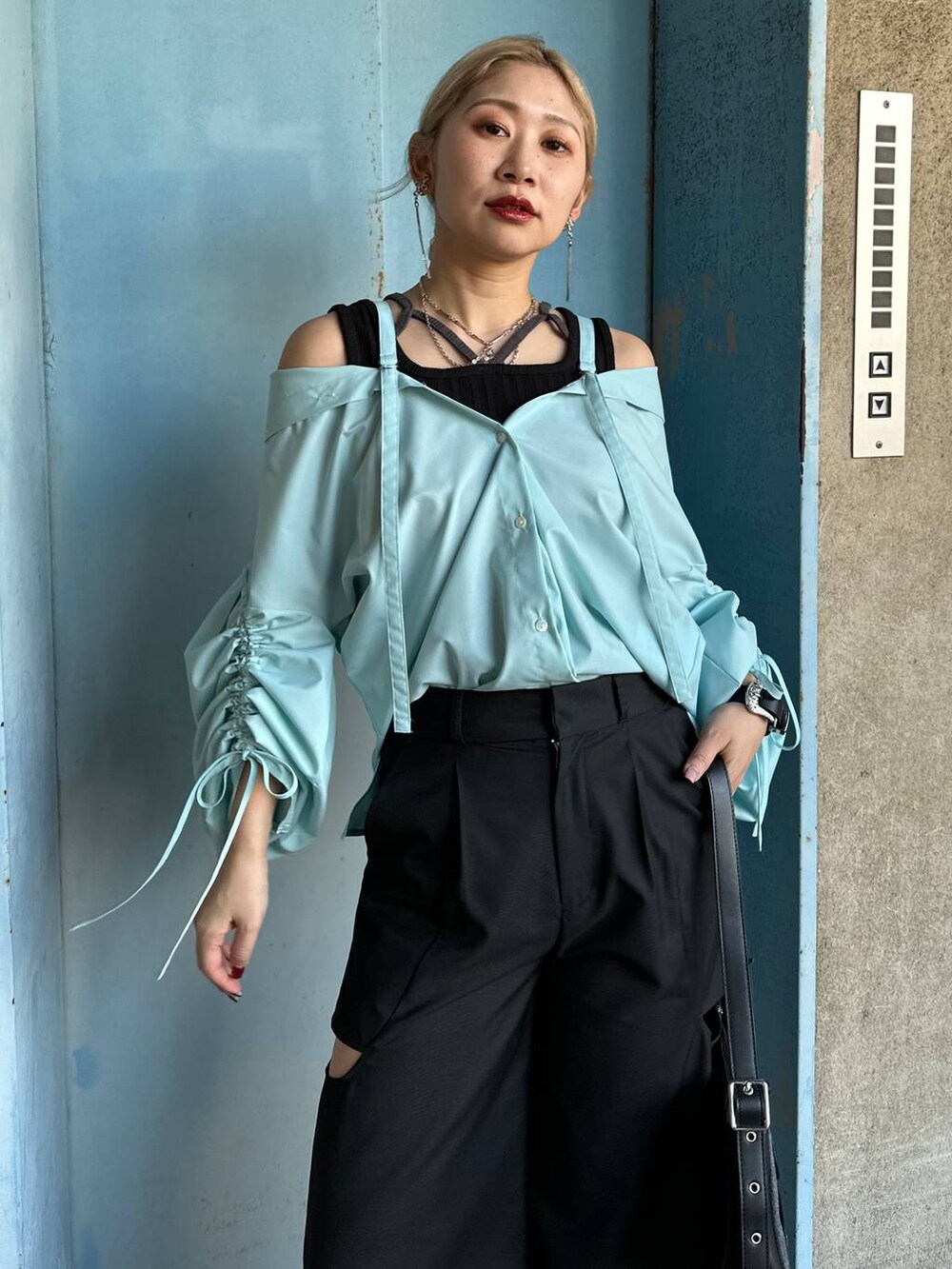 ブラック系のサンダル、ブルー系のシャツ/ブラウス、ブラック系のブレスレットを着用したレディースの春コーディネートの4枚目の写真