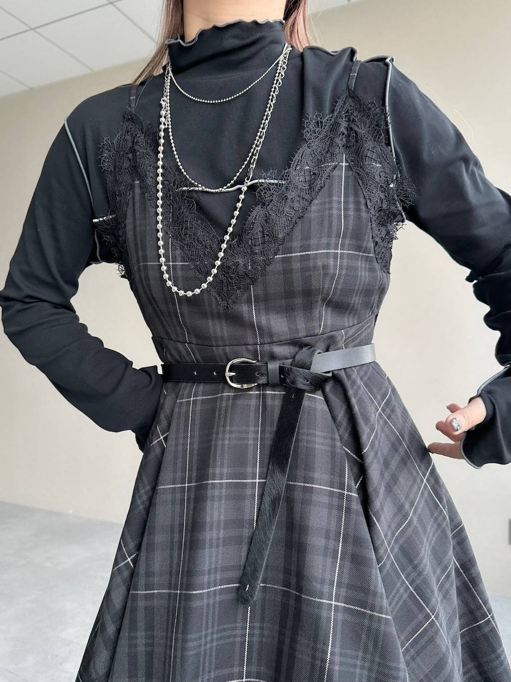 ブラック系のボストンバッグ、ブラック系のワンピース、ブラック系のブーツを着用したレディースの秋コーディネートの4枚目の写真