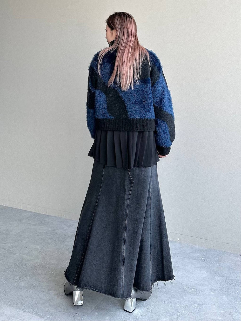 ブラック系のデニムスカート、シルバー系のブーツ、ブラック系のシャツ/ブラウスを着用したレディースの秋コーディネートの2枚目の写真