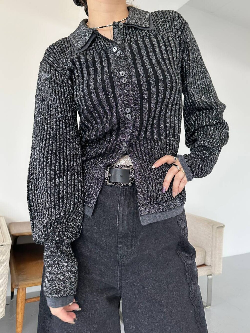 ブラック系のショルダーバッグ、ブラック系のデニムパンツ、ブラック系のブーツを着用したレディースの秋コーディネートの5枚目の写真