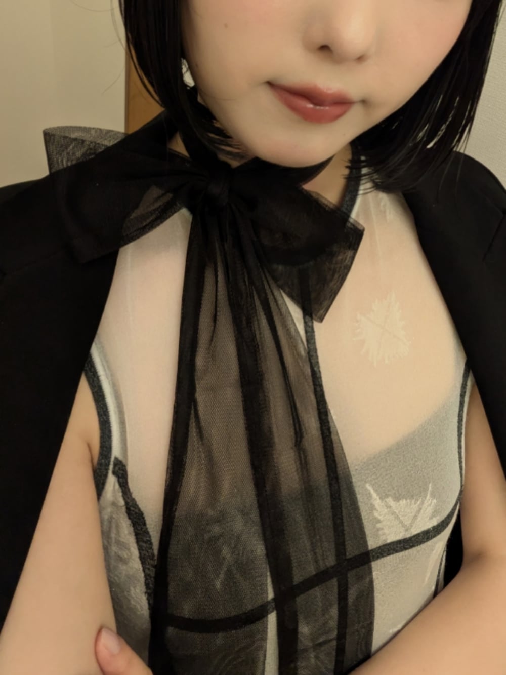 ホワイト系のワンピース、ブラック系のテーラードジャケット、ブラック系のストール/ショールを着用したレディースの春コーディネートの2枚目の写真