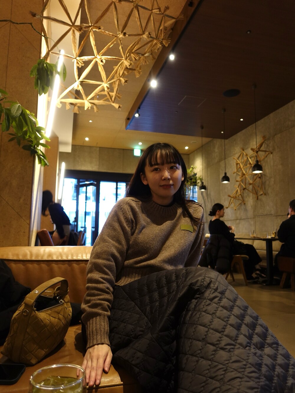 ベージュ系のニット/セーター、ブラック系のスカート、ベージュ系のスニーカーを着用したレディースの冬コーディネートの4枚目の写真