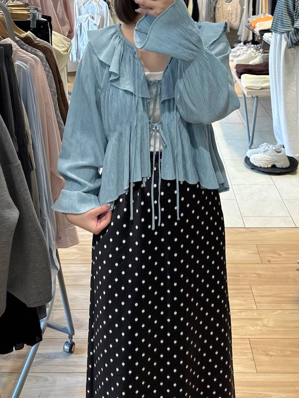 ブラック系のスカート、ブルー系のシャツ/ブラウスを着用したレディースの春コーディネートの2枚目の写真