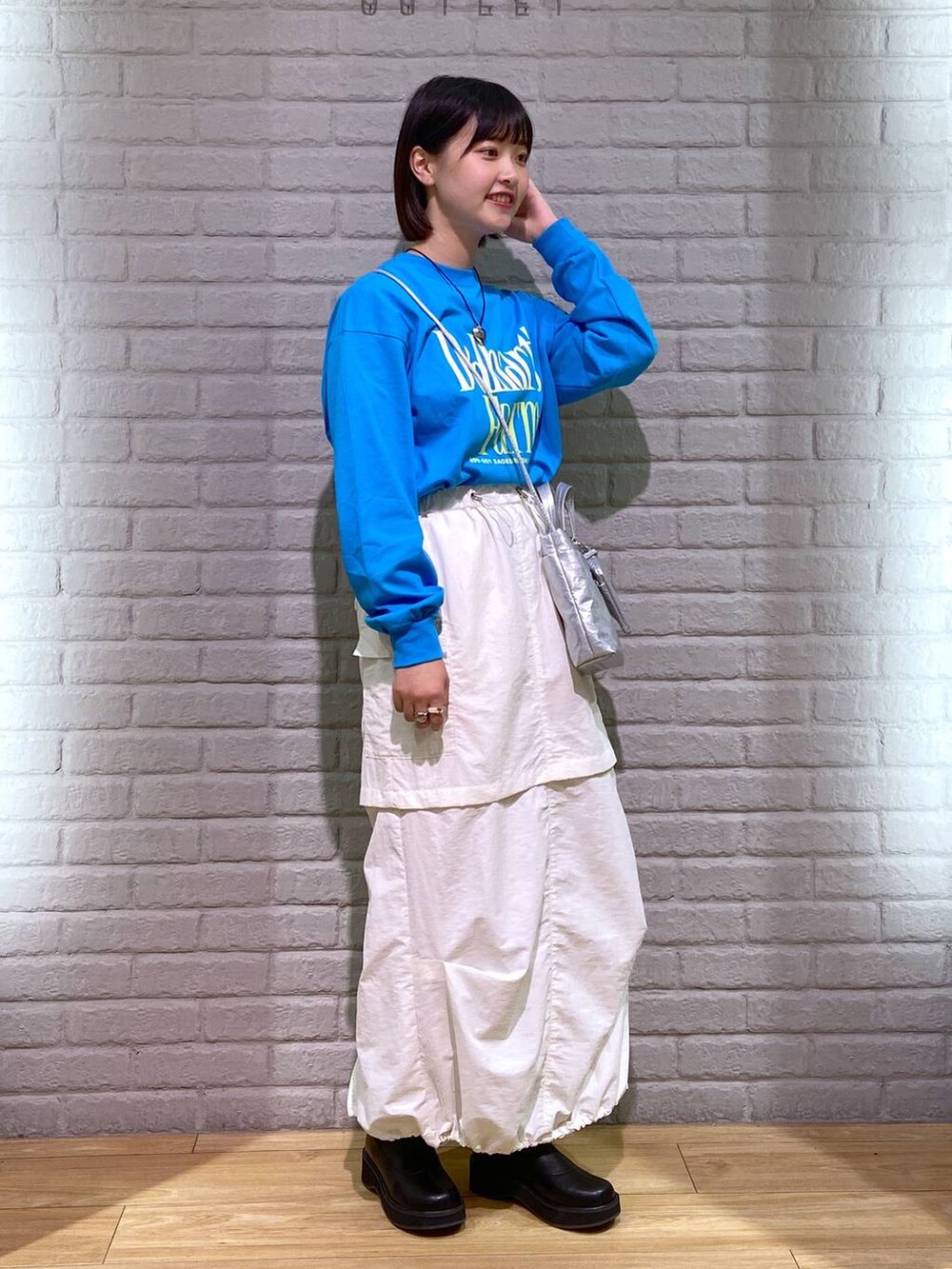 ブラック系のブーツ、シルバー系のショルダーバッグ、ブルー系のTシャツ/カットソーを着用したレディースの秋コーディネートの2枚目の写真