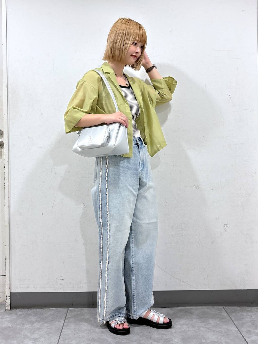 イエロー系のシャツ/ブラウス、ブラック系のタンクトップ、シルバー系のスニーカーを着用したレディースの夏コーディネートの2枚目の写真