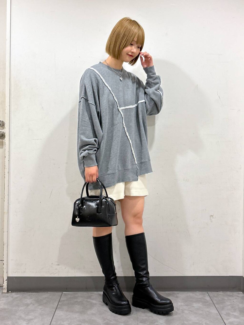 ブラック系のブーツ、ホワイト系のその他パンツ、グレー系のスウェットを着用したレディースの秋コーディネートの3枚目の写真