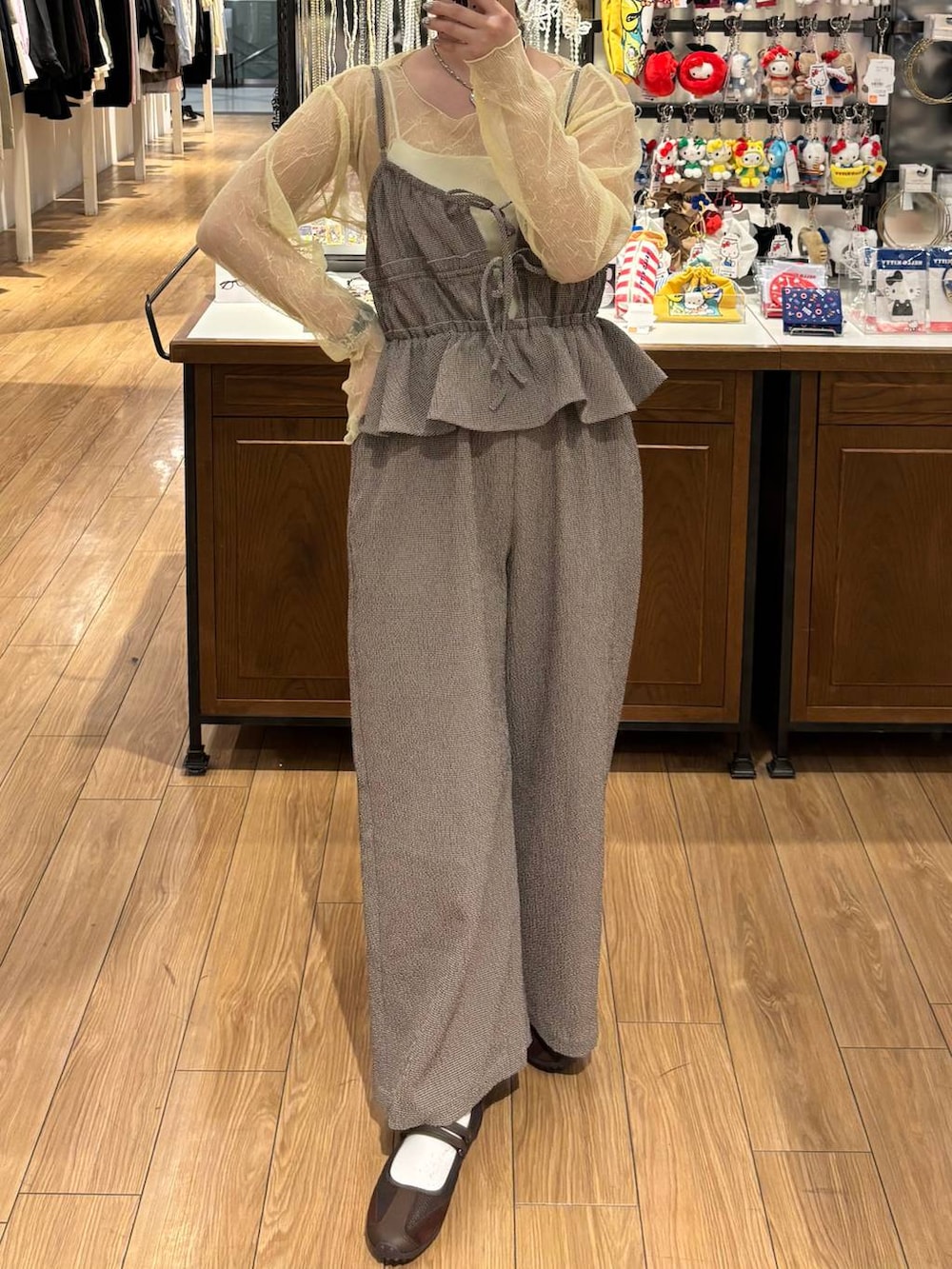 ブラウン系のスニーカー、イエロー系のTシャツ/カットソー、ブラウン系のサロペット/オーバーオールを着用したレディースの春コーディネートの2枚目の写真