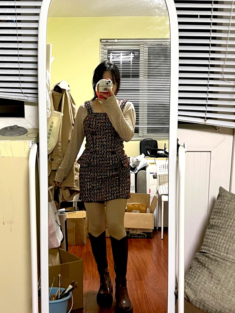 ベージュ系のトレンチコートを着用したレディースの秋コーディネートの2枚目の写真