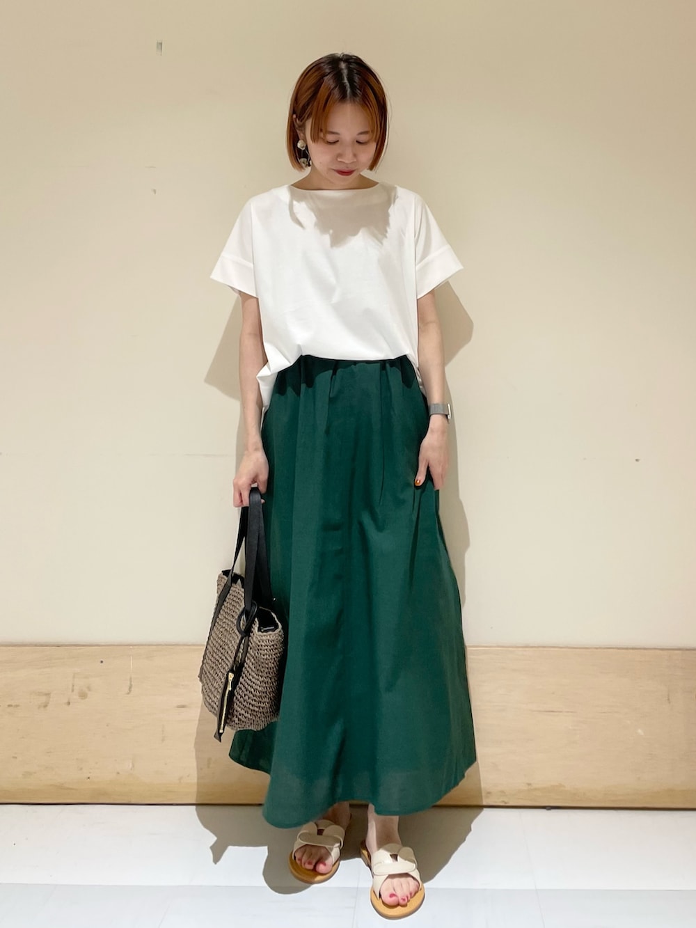 ホワイト系のTシャツ/カットソー、グレー系のトートバッグ、グリーン系のスカートを着用したレディースの夏コーディネートの4枚目の写真