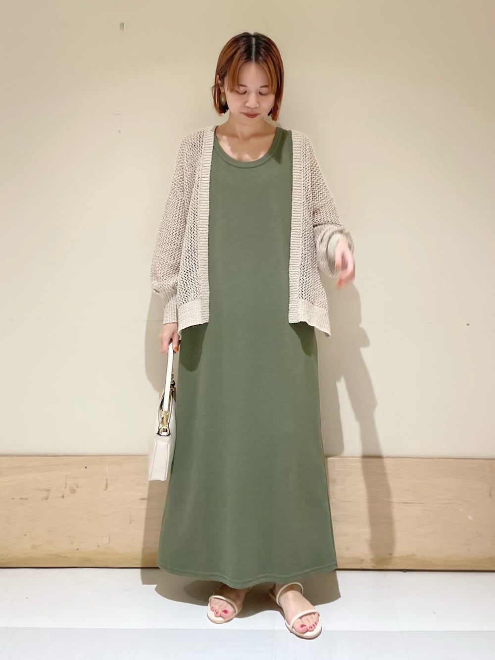 ベージュ系のショルダーバッグ、ホワイト系のサンダル、ホワイト系のカーディガン/ボレロを着用したレディースの夏コーディネートの4枚目の写真