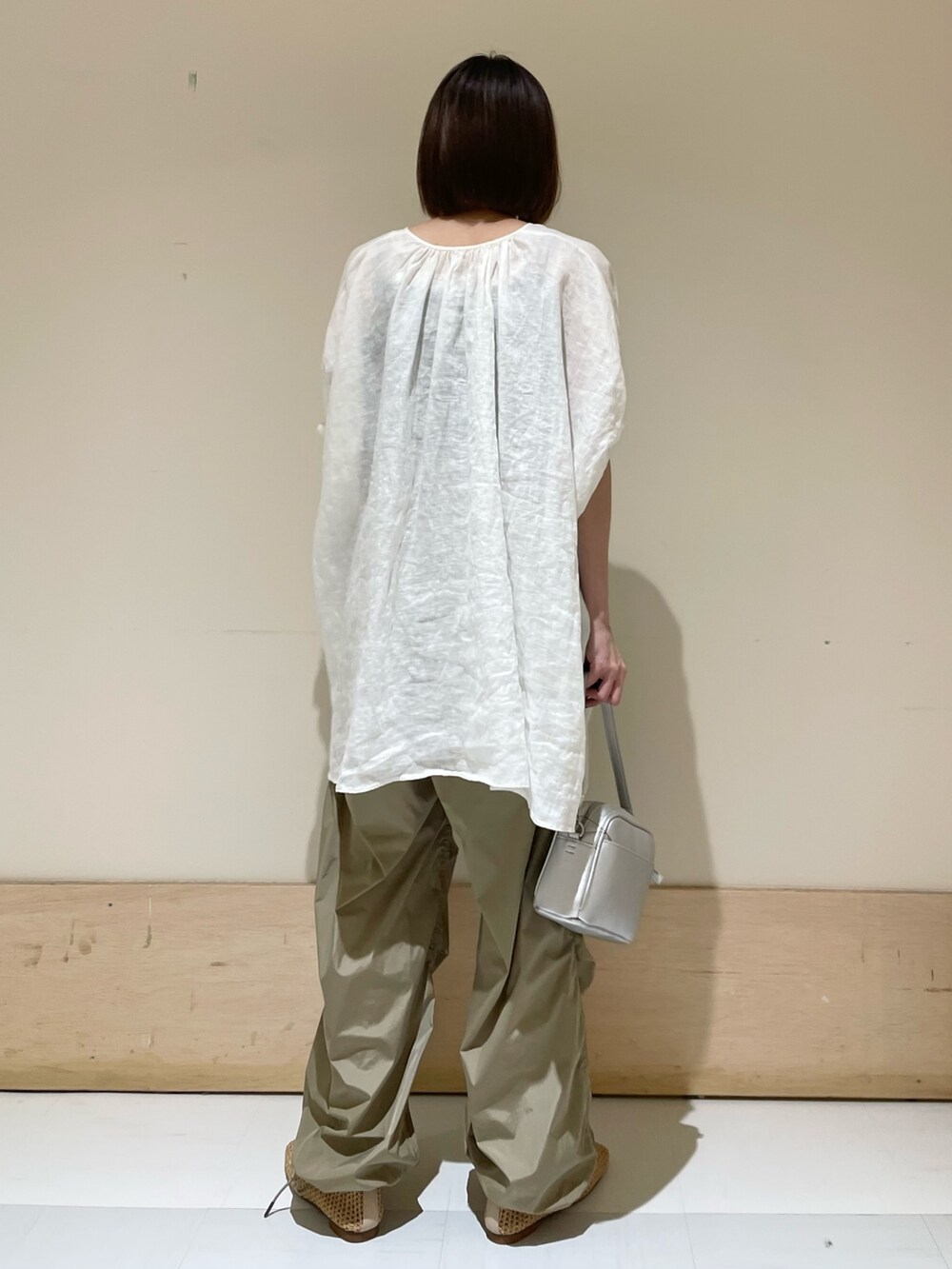 ホワイト系のシャツ/ブラウス、ベージュ系のバレエシューズ、シルバー系のショルダーバッグを着用したレディースの夏コーディネートの7枚目の写真
