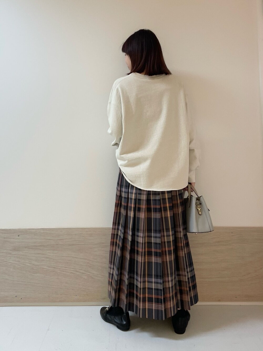 ホワイト系のスウェット、グレー系のスカートを着用したレディースの冬コーディネートの6枚目の写真