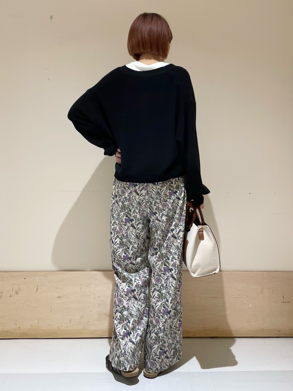 パープル系のその他パンツ、ブラック系のニット/セーター、ホワイト系のタンクトップを着用したレディースの春コーディネートの7枚目の写真