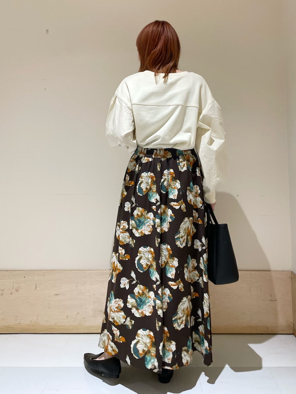 ブラウン系のスカート、ホワイト系のTシャツ/カットソーを着用したレディースの冬コーディネートの4枚目の写真