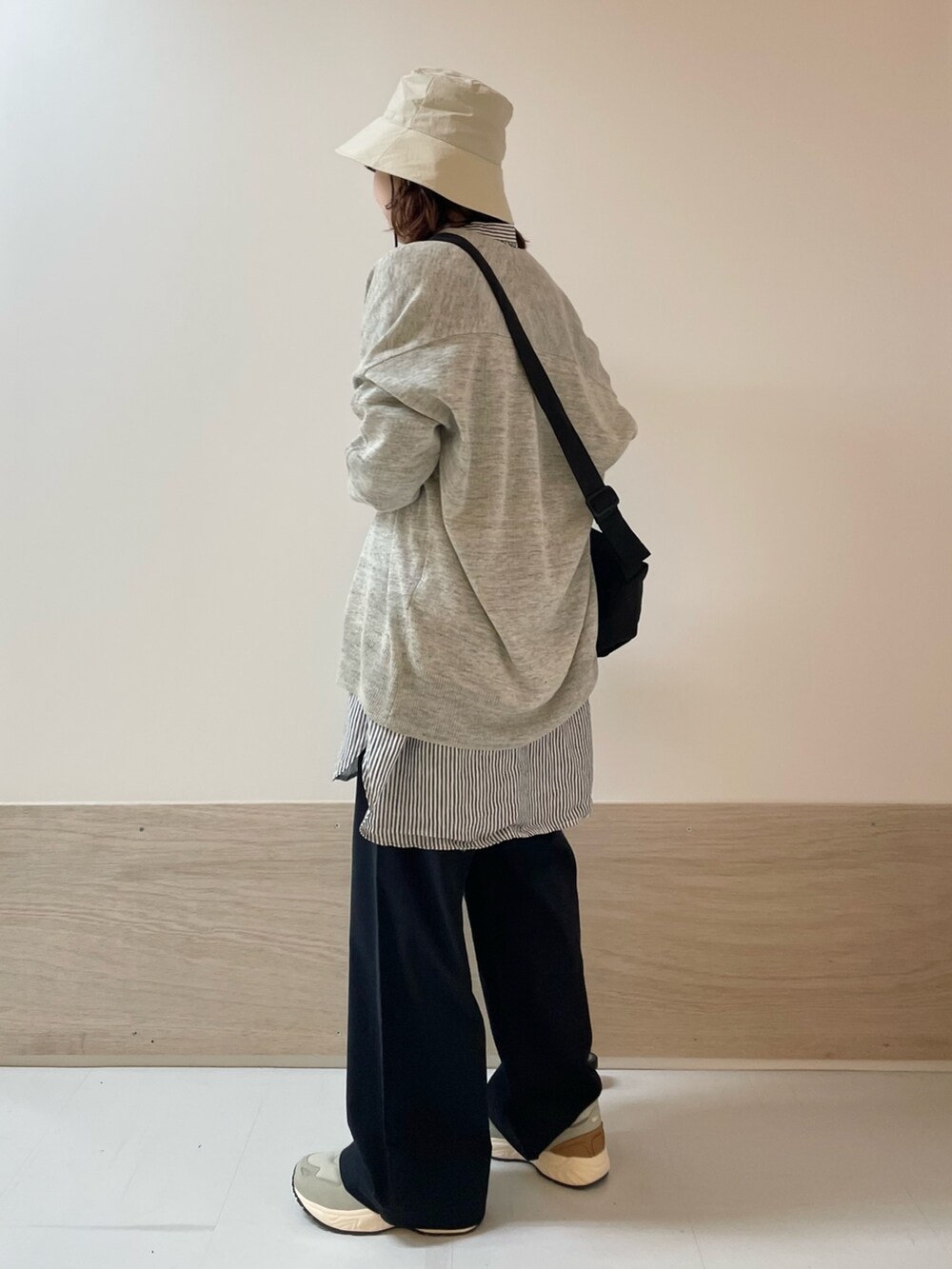 ブルー系のその他パンツ、グレー系のスニーカー、ブラック系のショルダーバッグを着用したレディースの春コーディネートの4枚目の写真