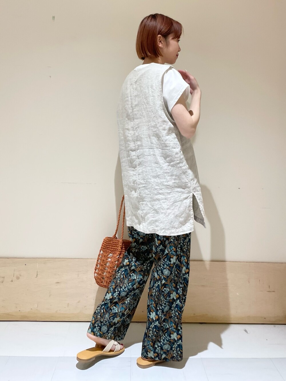 ブルー系のその他パンツ、ブラウン系のかごバッグ、ホワイト系のTシャツ/カットソーを着用したレディースの春コーディネートの6枚目の写真