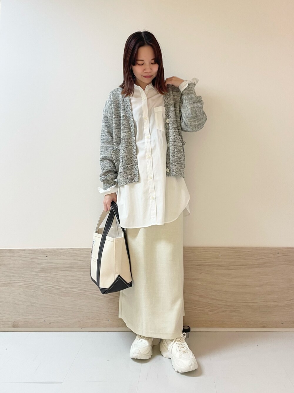 ホワイト系のスカート、ブルー系のカーディガン/ボレロ、ホワイト系のシャツ/ブラウスを着用したレディースの春コーディネートの2枚目の写真