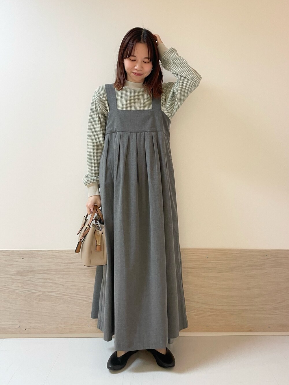 ブラック系のパンプス、グレー系のワンピース、グリーン系のTシャツ/カットソーを着用したレディースの春コーディネートの2枚目の写真