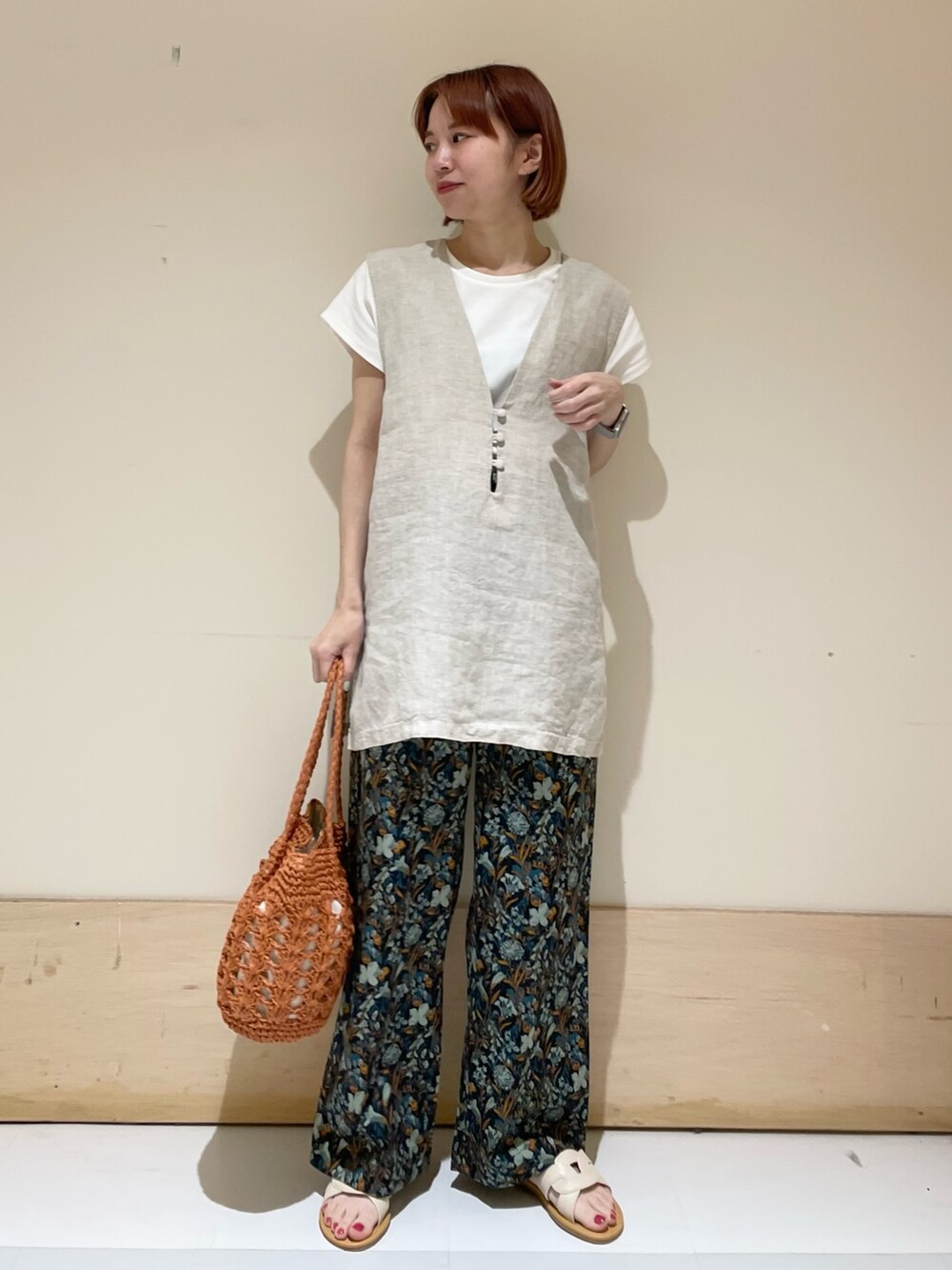 ブルー系のその他パンツ、ブラウン系のかごバッグ、ホワイト系のTシャツ/カットソーを着用したレディースの春コーディネートの2枚目の写真