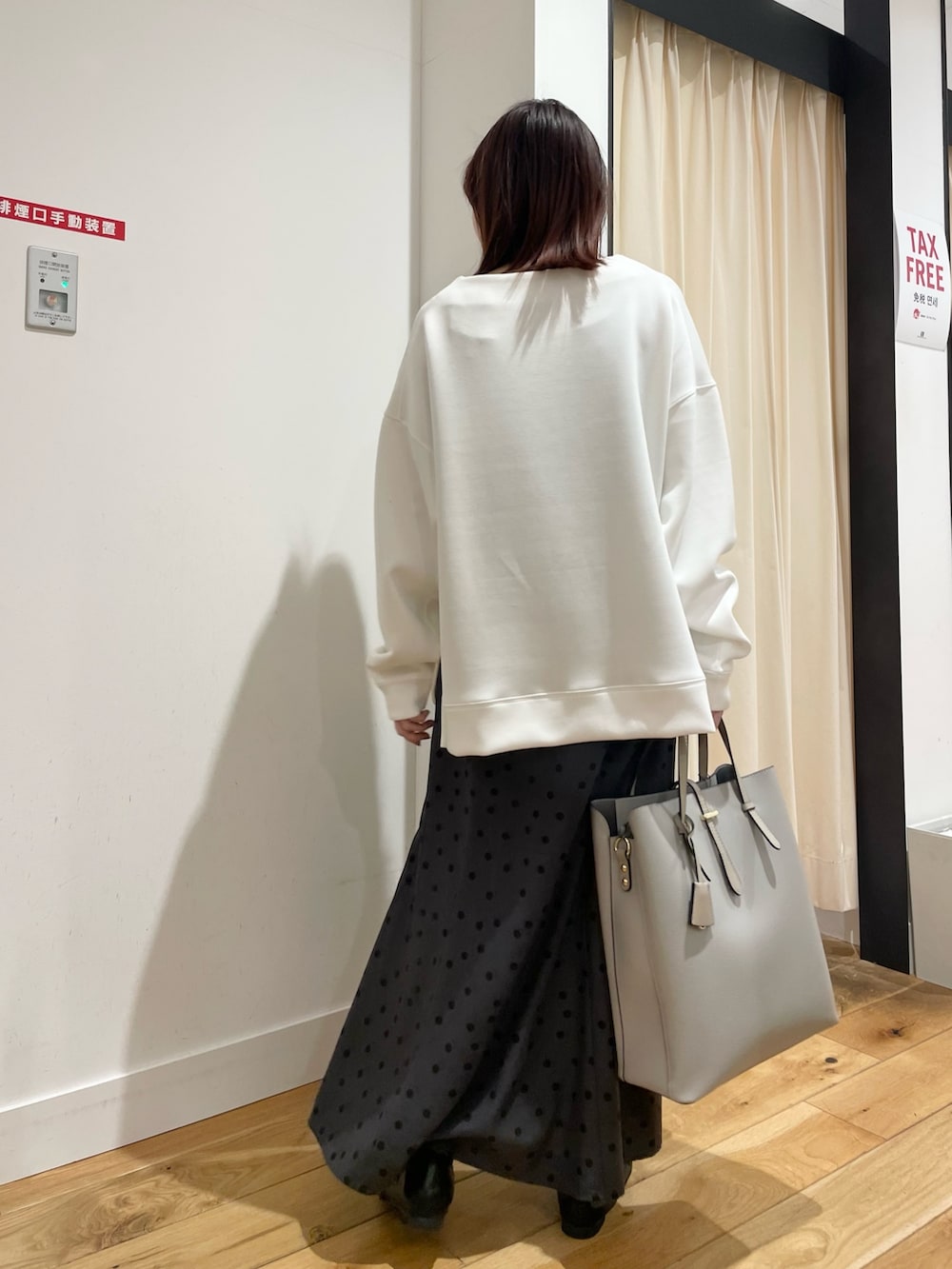 ホワイト系のTシャツ/カットソー、グレー系のスカートを着用したレディースの春コーディネートの4枚目の写真