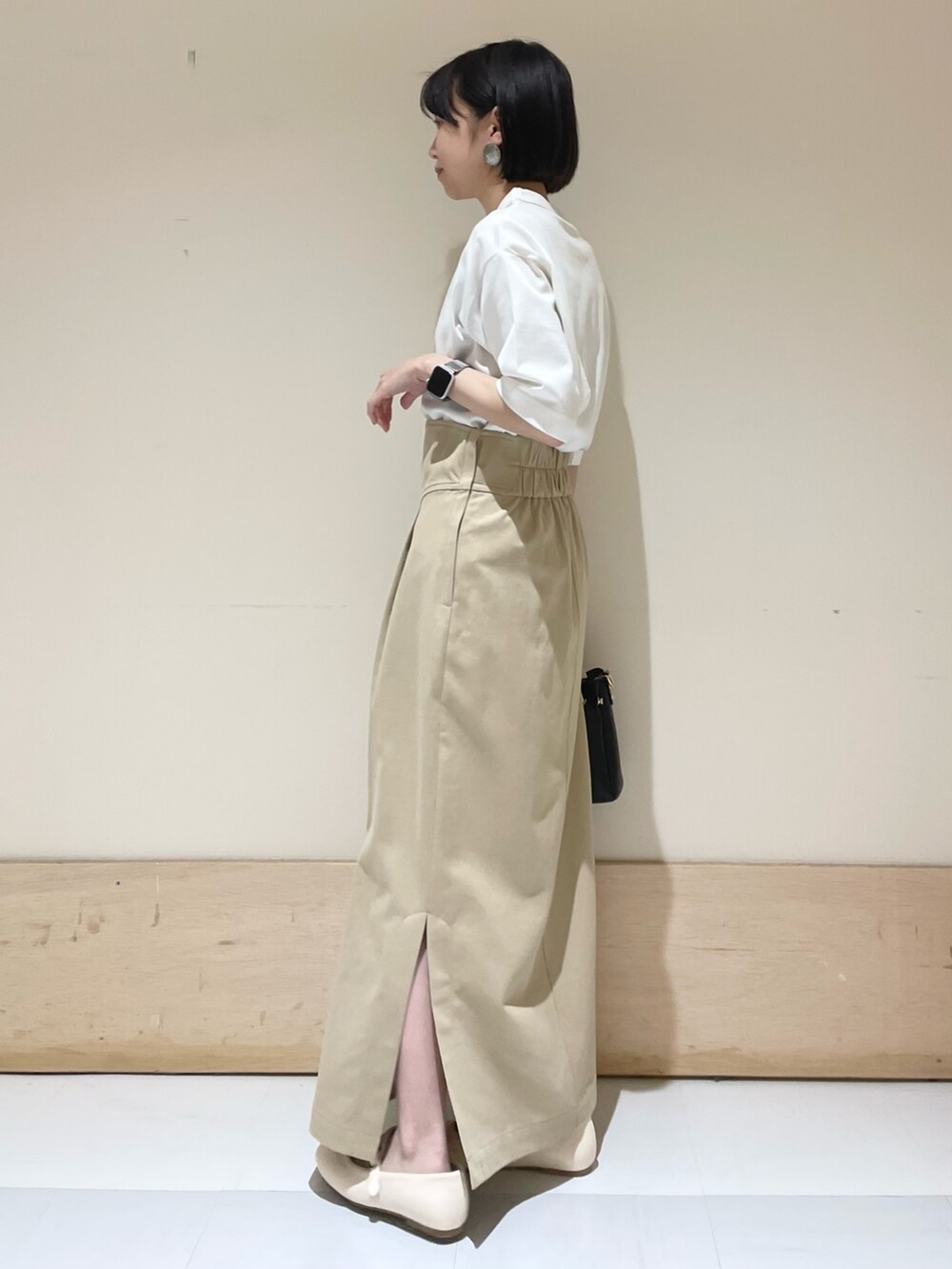 ホワイト系のTシャツ/カットソー、ブラック系のトートバッグ、ベージュ系のスカートを着用したレディースの夏コーディネートの4枚目の写真