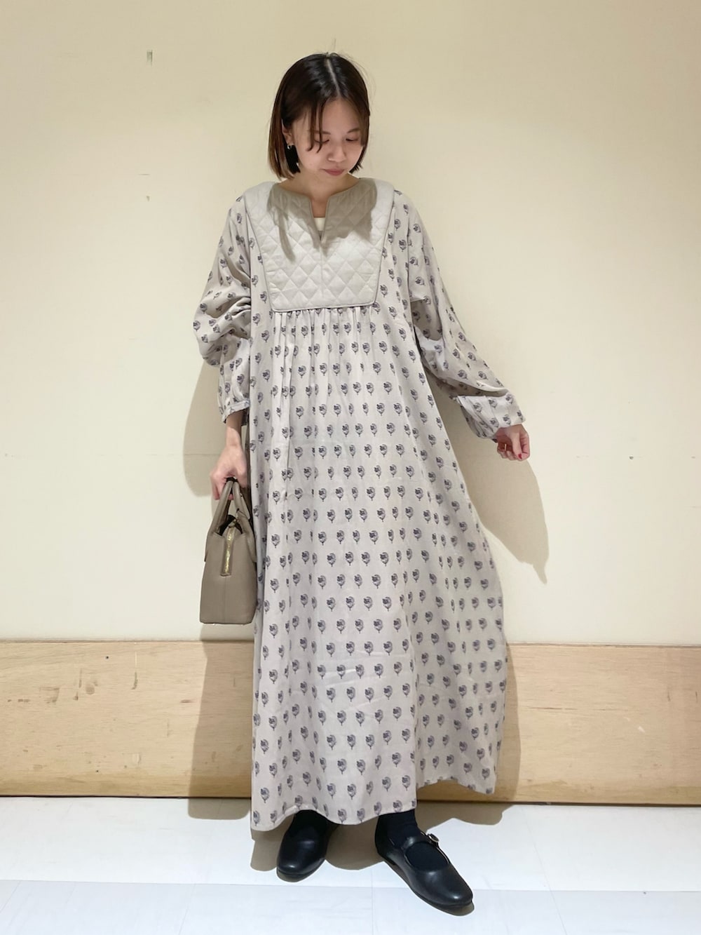 ブラック系のその他シューズ、ベージュ系のワンピース、グレー系のショルダーバッグを着用したレディースの秋コーディネートの4枚目の写真