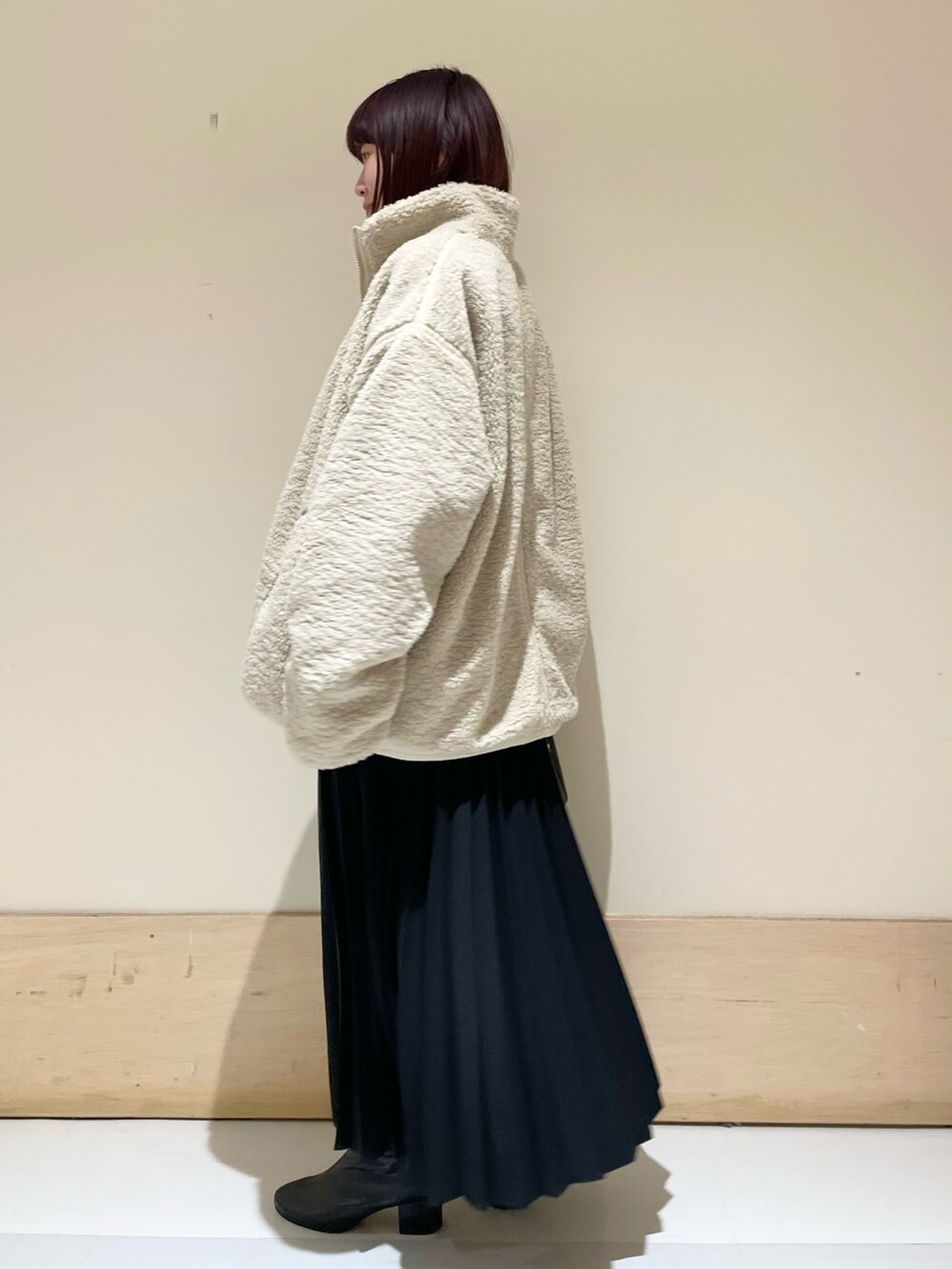 ピンク系のニット/セーター、ホワイト系のブルゾン、ブラック系のスカートを着用したレディースの冬コーディネートの5枚目の写真