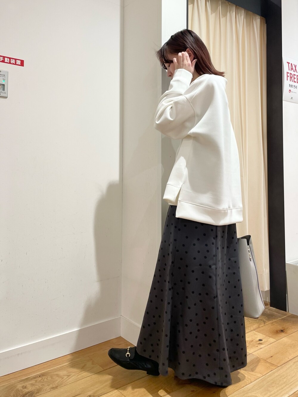 ホワイト系のTシャツ/カットソー、グレー系のスカートを着用したレディースの春コーディネートの7枚目の写真