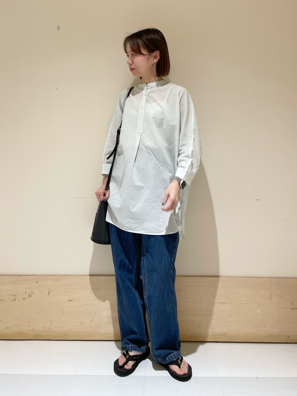 グリーン系のシャツ/ブラウス、ブルー系のデニムパンツ、ブラック系のサンダルを着用したレディースの夏コーディネートの3枚目の写真