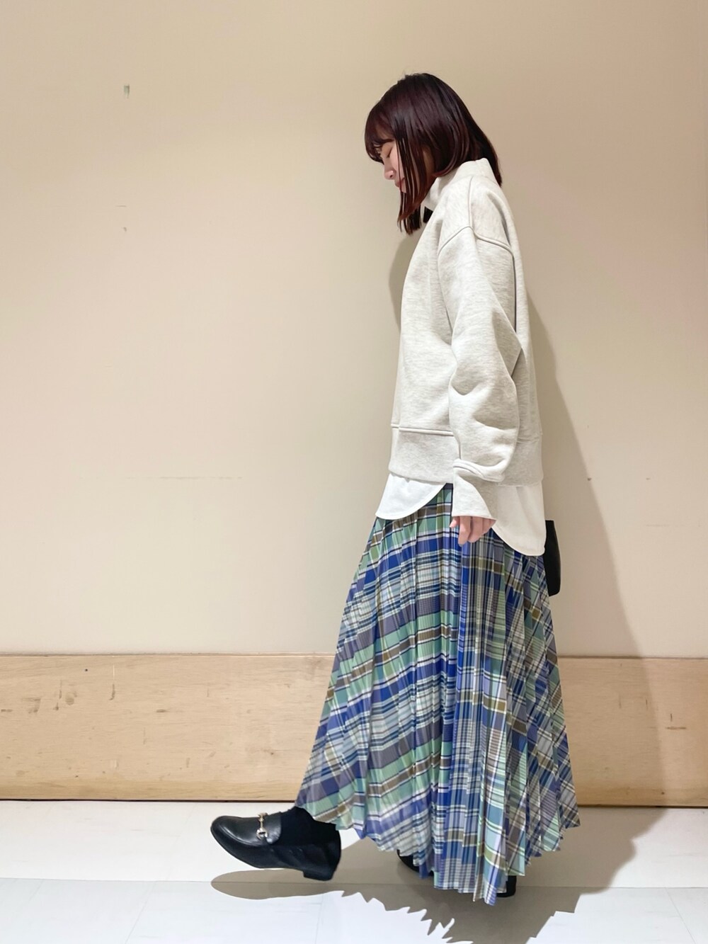 グリーン系のスカート、グレー系のTシャツ/カットソー、ホワイト系のTシャツ/カットソーを着用したレディースの冬コーディネートの4枚目の写真