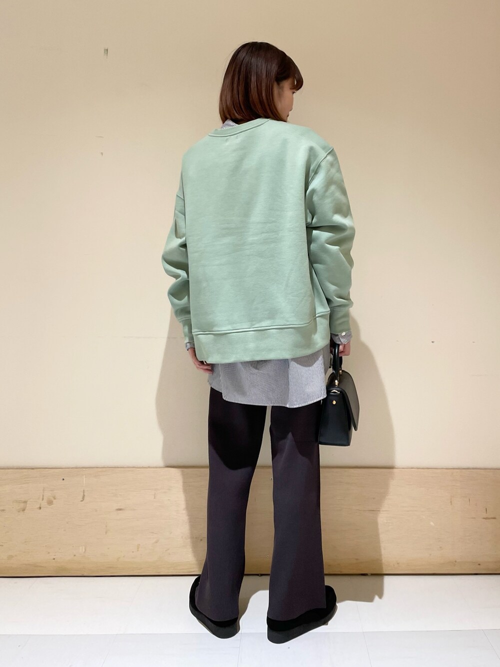 ブルー系のシャツ/ブラウス、グリーン系のスウェット、ブラック系のショルダーバッグを着用したレディースの冬コーディネートの6枚目の写真