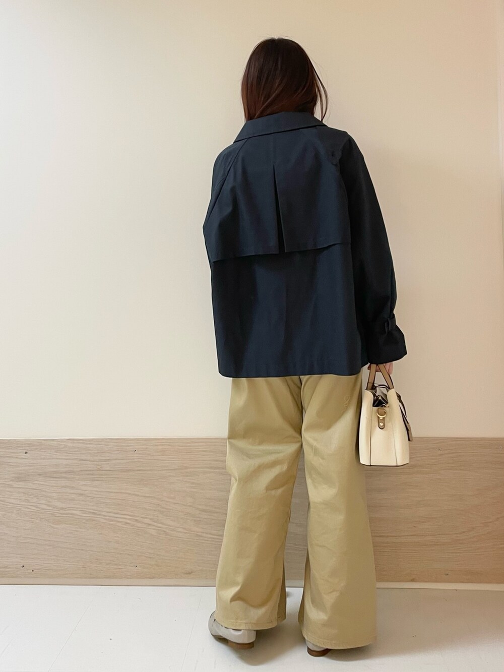 ブルー系のトレンチコート、グリーン系のニット/セーター、ベージュ系のその他パンツを着用したレディースの春コーディネートの5枚目の写真