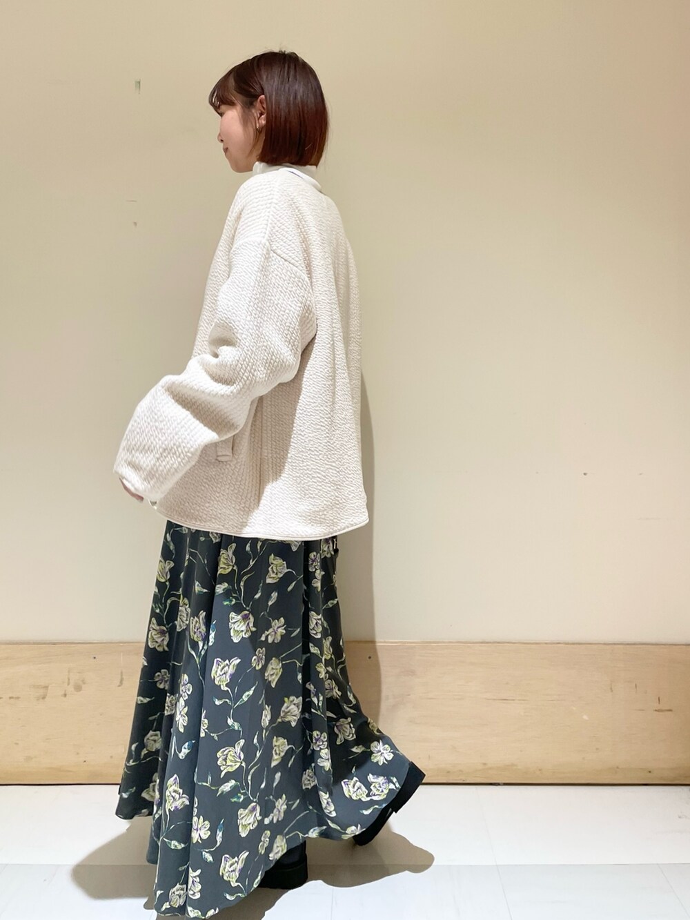 ホワイト系のTシャツ/カットソー、ホワイト系のノーカラージャケット、グレー系のスカートを着用したレディースの秋コーディネートの5枚目の写真