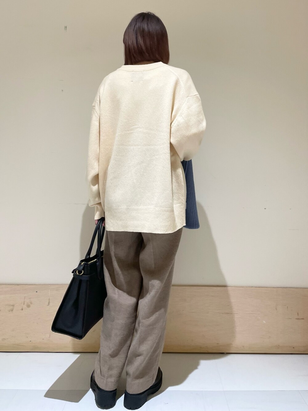 ホワイト系のニット/セーター、ホワイト系のカーディガン/ボレロ、ベージュ系のその他パンツを着用したレディースの秋コーディネートの5枚目の写真