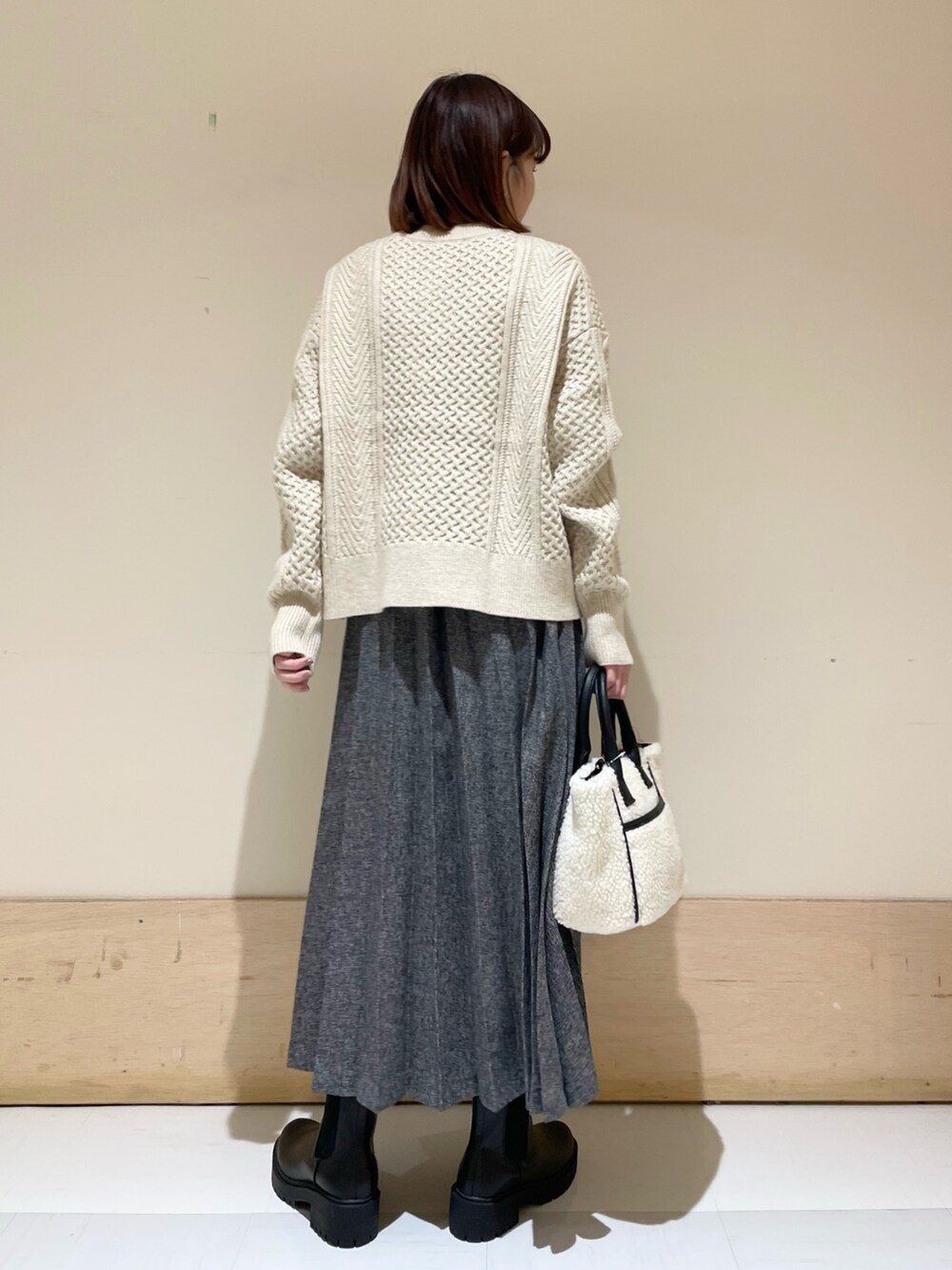 ホワイト系のカーディガン/ボレロ、ブルー系のスカート、ホワイト系のショルダーバッグを着用したレディースの冬コーディネートの7枚目の写真