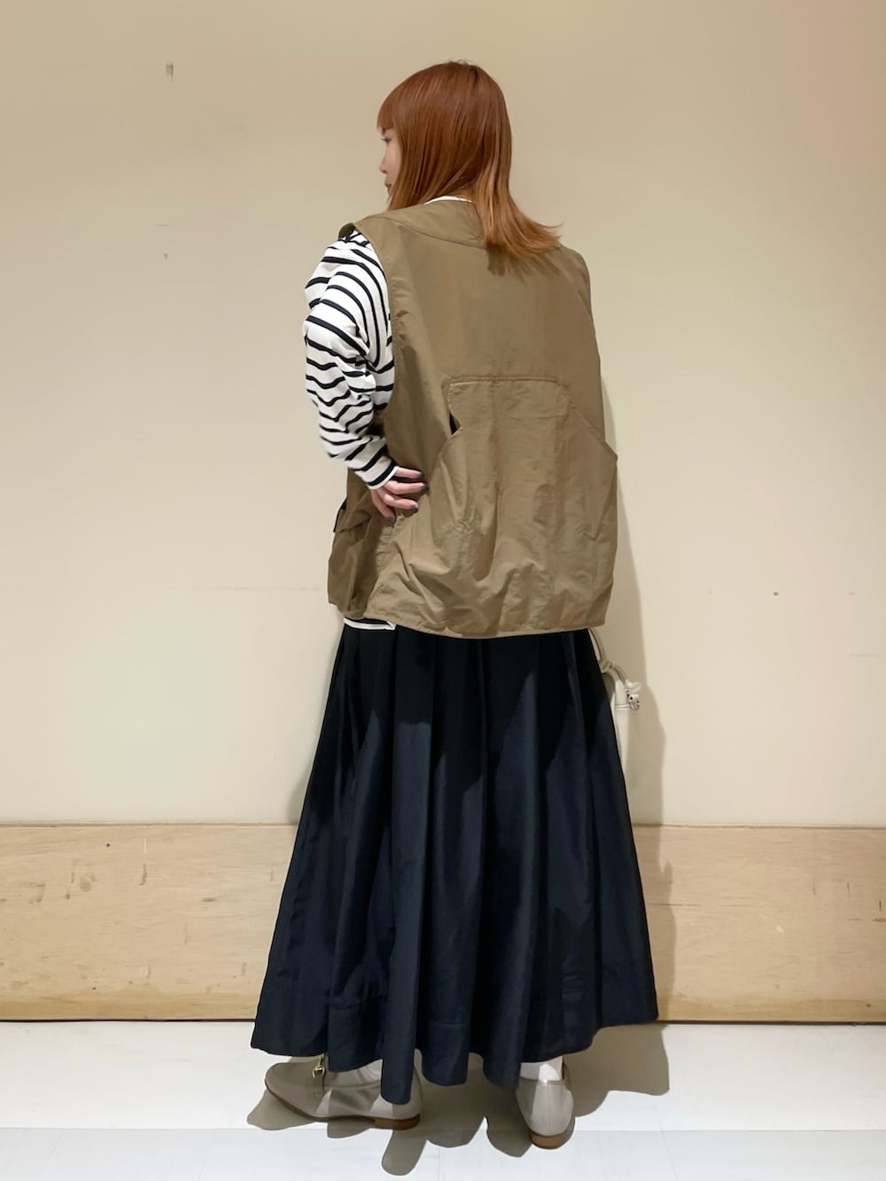 ブルー系のスカート、ブルー系のTシャツ/カットソー、ベージュ系のショルダーバッグを着用したレディースの春コーディネートの5枚目の写真