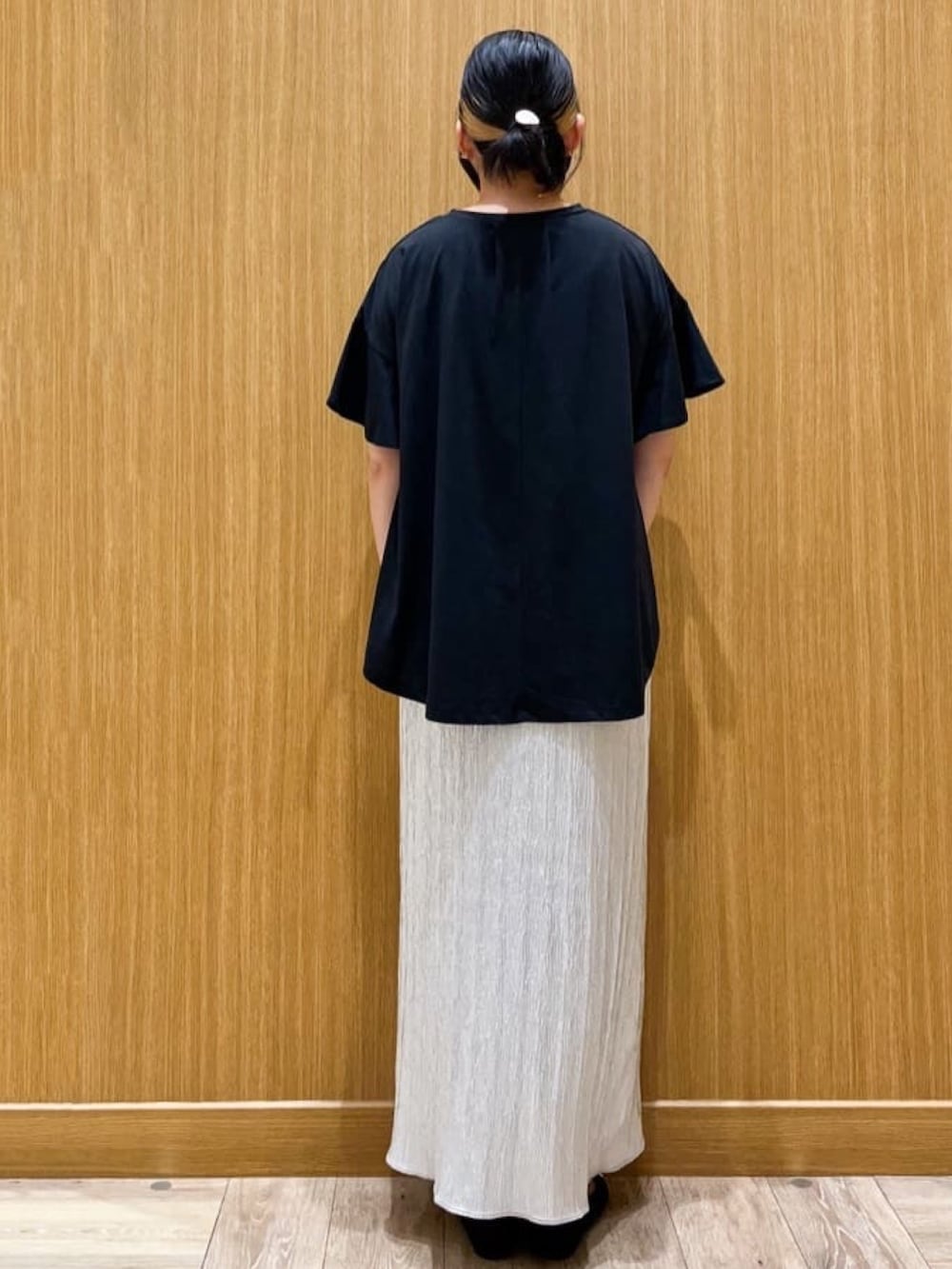 ブラック系のTシャツ/カットソー、シルバー系のスカート、ブラック系のパンプスを着用したレディースの夏コーディネートの2枚目の写真