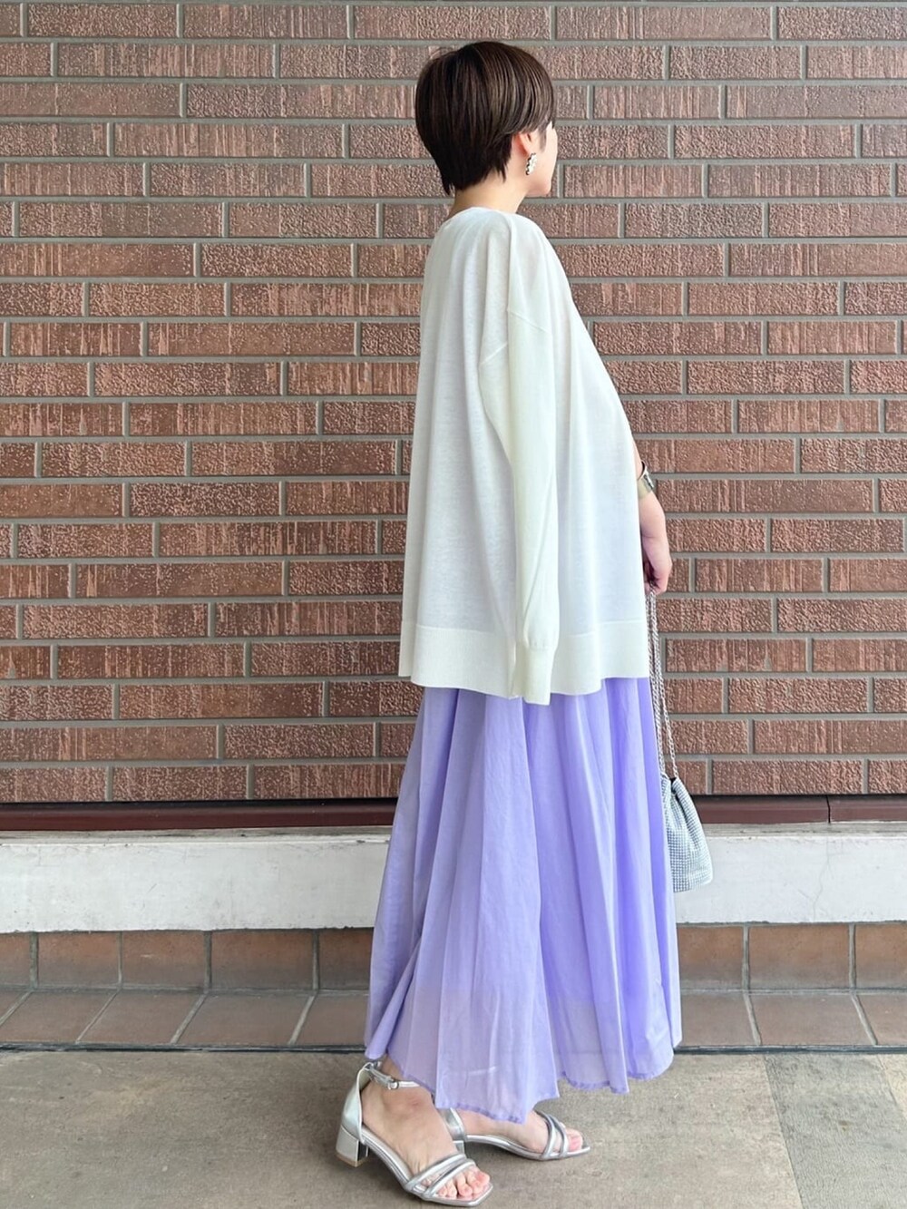 ホワイト系のカーディガン/ボレロ、パープル系のワンピース、ホワイト系のショルダーバッグを着用したレディースの夏コーディネートの3枚目の写真