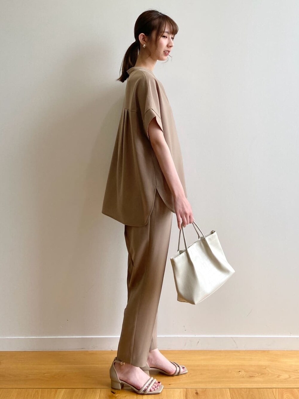 イエロー系のシャツ/ブラウス、イエロー系のその他パンツ、ベージュ系のサンダルを着用したレディースの夏コーディネートの4枚目の写真