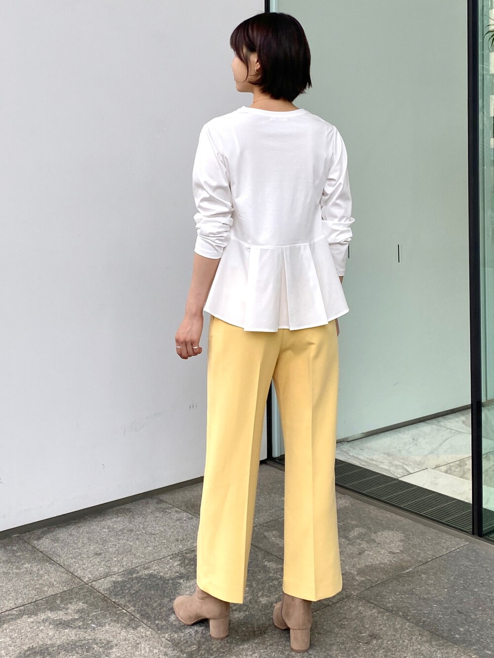 ホワイト系のTシャツ/カットソー、イエロー系のその他パンツ、ゴールド系のネックレスを着用したレディースの秋コーディネートの3枚目の写真