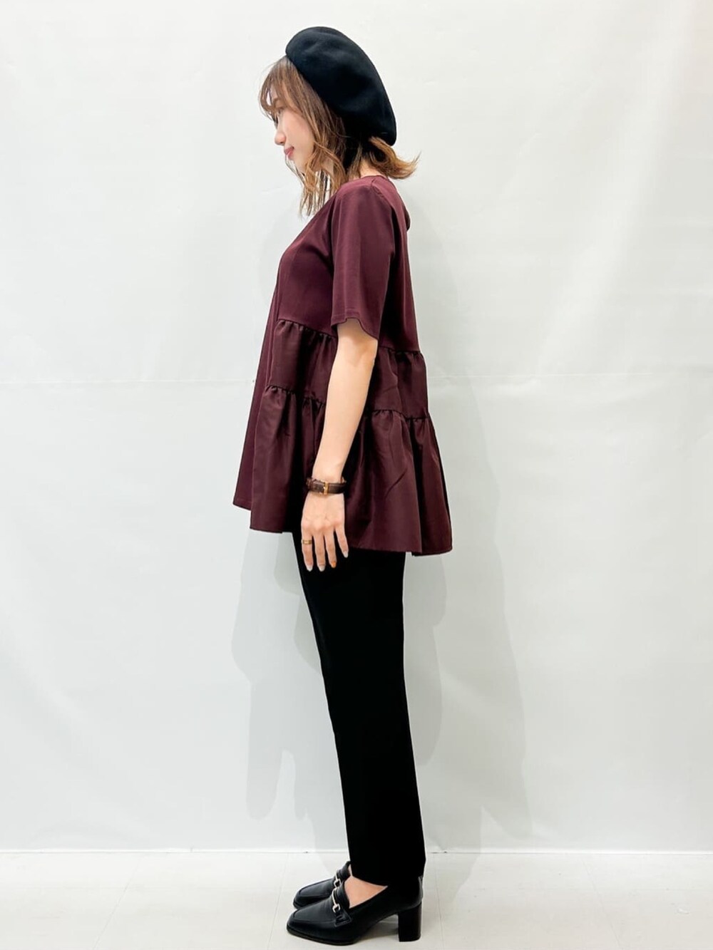 ブラック系のボストンバッグ、レッド系のTシャツ/カットソー、ブラック系のその他パンツを着用したレディースの秋コーディネートの2枚目の写真