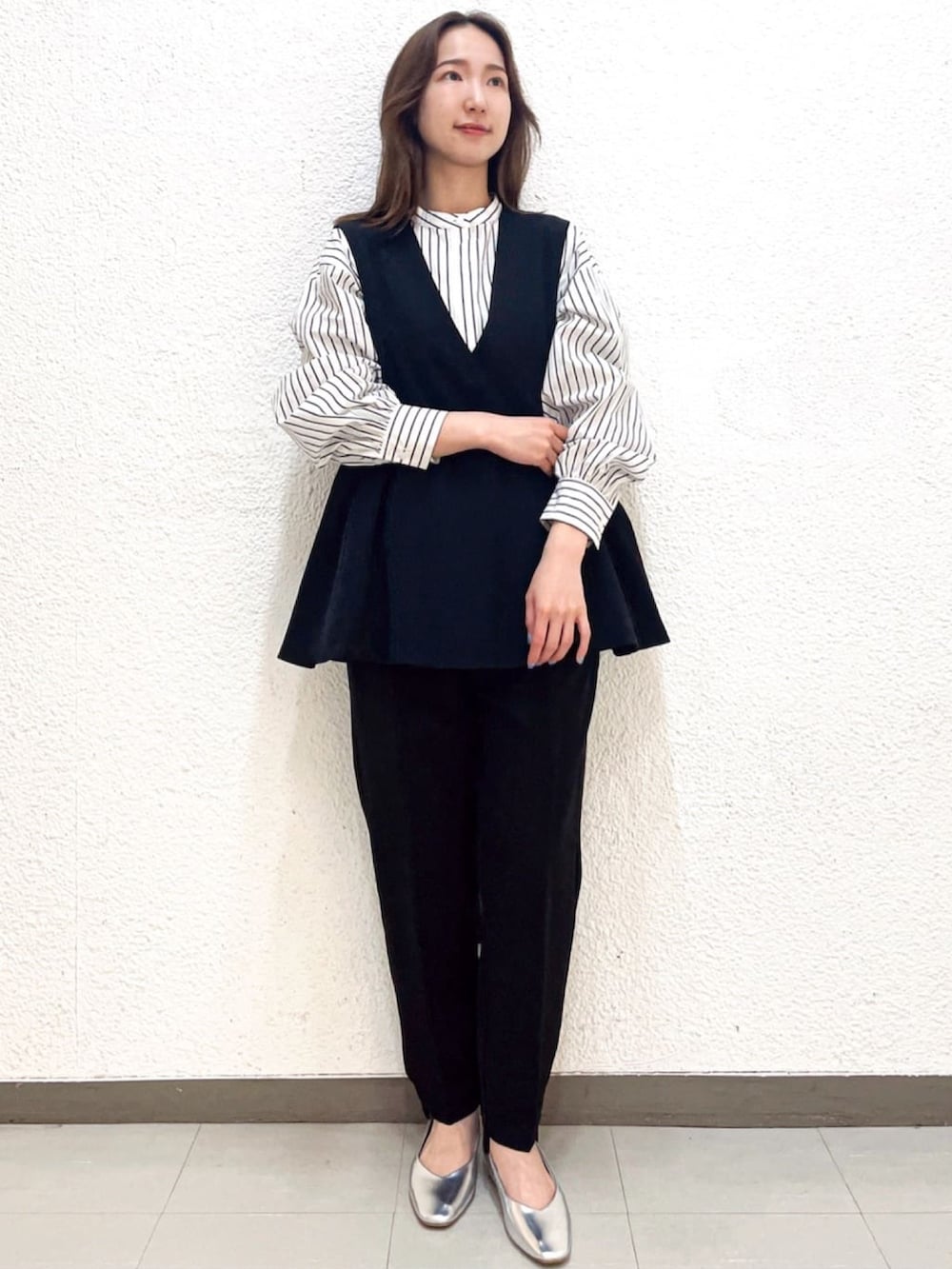 ホワイト系のシャツ/ブラウス、ブラック系のベスト、ブラック系のその他パンツを着用したレディースの冬コーディネートの2枚目の写真