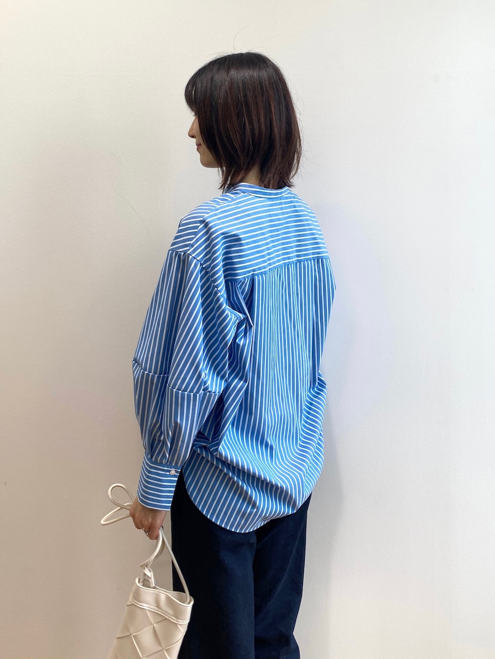 ブラウン系のサンダル、ブルー系のシャツ/ブラウス、ホワイト系のニット/セーターを着用したレディースの春コーディネートの6枚目の写真