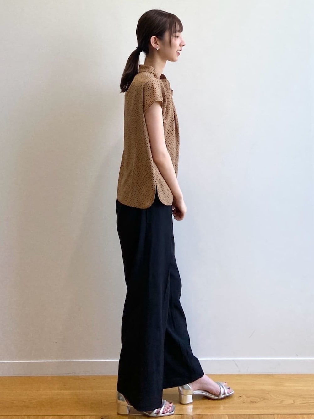 イエロー系のシャツ/ブラウス、ブラック系のその他パンツ、シルバー系のサンダルを着用したレディースの夏コーディネートの3枚目の写真