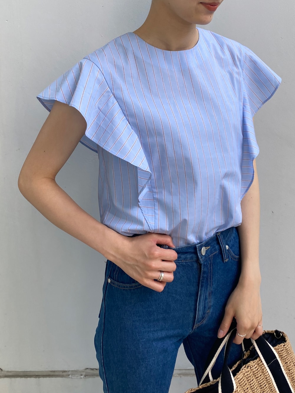 ブルー系のシャツ/ブラウス、ブルー系のデニムパンツ、ブラック系のトートバッグを着用したレディースの夏コーディネートの3枚目の写真