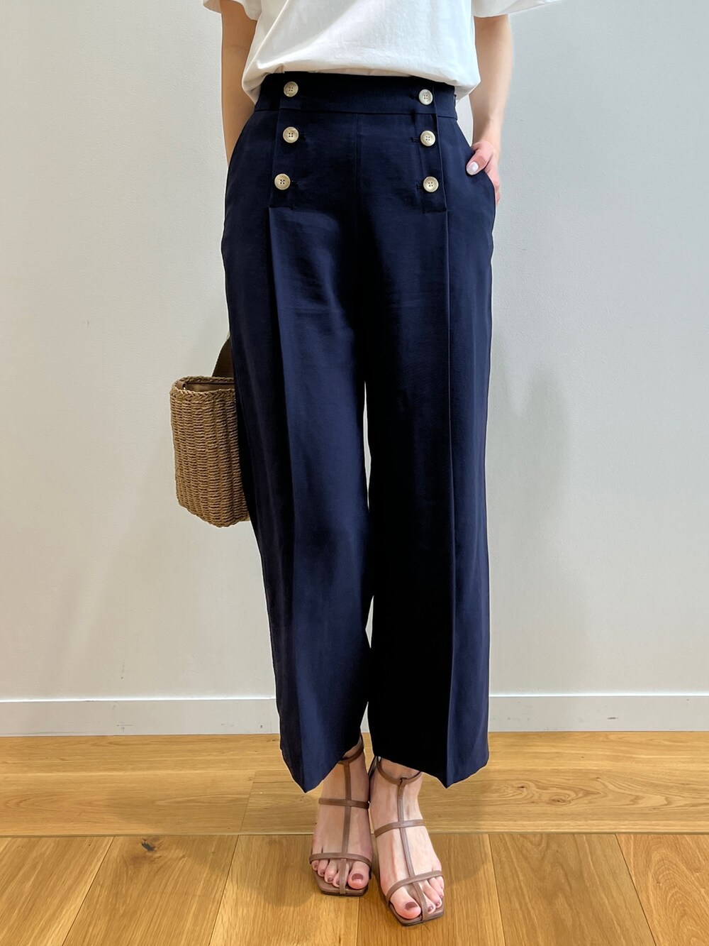 ブラウン系のサンダル、ホワイト系のTシャツ/カットソー、ゴールド系のトートバッグを着用したレディースの春コーディネートの6枚目の写真