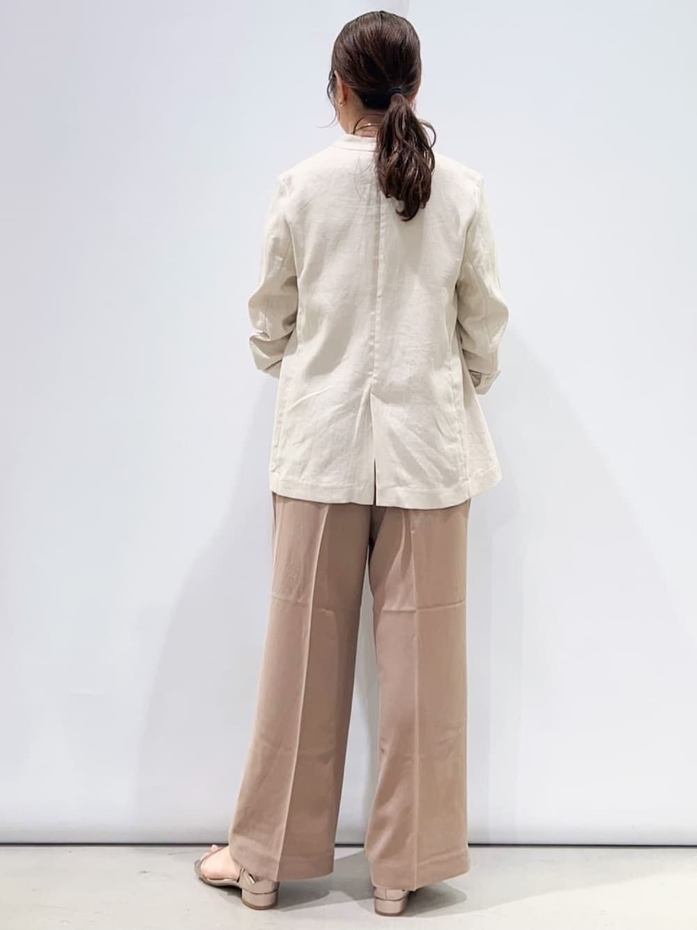 ゴールド系のサンダル、ホワイト系のニット/セーター、ベージュ系のその他パンツを着用したレディースの春コーディネートの3枚目の写真