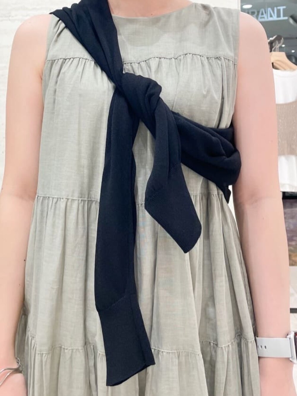 グリーン系のワンピース、シルバー系のショルダーバッグ、ブラック系のサンダルを着用したレディースの夏コーディネートの2枚目の写真